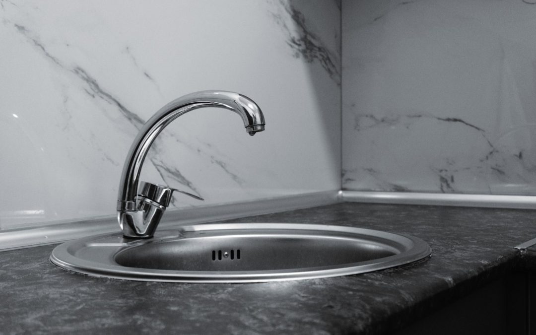 Sleek stainless steel sink and faucet in a contemporary kitchen setting.