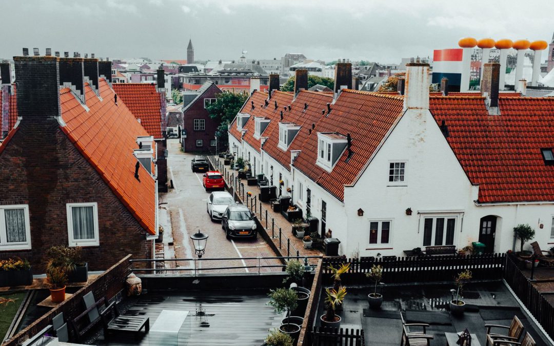 Aerial view of a picturesque Dutch neighborhood featuring iconic red-tiled roofs and charming architecture.
